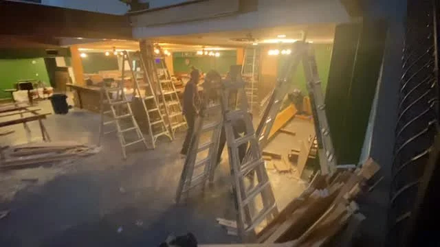 Ladders and lumber across the pub floor as the ceiling beams go in