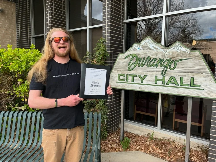Jimmy holding the license application outside Durango City Hall